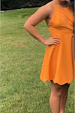 I wore this for a late summer wedding, and I was pretty pleased with it. I'm a little on the short side, but nothing like a pair of heels can't fix. It was slightly loose up top because of my smaller bust, but there were adjustable strings. I highly recommend wearing pasties. Overall, super pretty dress and I was in love with the criss-cross back! - Kathy D.