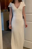 This dress is made for someone 6 feet tall but it's really pretty. The quality is great. The color is ivory, not white. If you're small you'll definitely need to have us tailored but I wouldn't size down. - Elaine S.