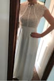 I just received this dress in the mail, and I believe I am saying YES to this dress!!! The fabric feels so luxurious and I just love the fit and the cap lace sleeves. It makes me feel so feminine. If you are at all thinking about this dress (since as of the time of this writing it has no reviews)- go for it!! The ONLY thing that is super bummer is the zipper in the back- I think it was a production error and it the very bottom of the zipper sticks out of the dress. Super weird, so I will be returning and hope that a re-order will be perfect and not have the same issue. I can wear a regular bra underneath as its lined and not see thru. 

**update** received the second one in the mail and it fits even better and no issue with quality. - Amy N.