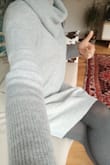 I am very pleased with this dress. The light grey color is just so calming and it keeps my neck nice and warm for Autumn right now. I'm 161 cm tall and the dress falls to about 3 - 4 cm from my knees. It is unlined so it may be best to wear a slip underneath if you don't want people to see your legs through the light. Would love to purchase different colors once this whole Covid 19 settles down! - Jes H.