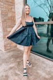 I love this dress! You can tie the straps on both sides to adjust to your liking. The only downside is it is a very short dress, so it worked well for me because I am short, but if you are really tall it may not be the best choice. I love how simple it is and it matches everything. - Cristina B.