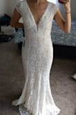 Gorgeous dress! I loved the white lace with the nude underlay! It is my favorite color since it compliments my medium skin tone. The quality of the lace is amazing. It highlighted my hips and waist beautifully. Since it does not come with cups and I don't have much bust, I tried it on with a strapless bra. Personally I was did not feel very comfortable with the deep v neck. If I were to choose this dress, I would have gotten an XS size and breast cups sewn in by a tailor. The skirt has a beautiful mermaid shape and a lovely movement. I strongly recommend this dress if you don't mind the deep V cut! - Ayca C.