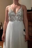 The beaded bodice of this dress is so gorgeous! Paired with the plain skirt, it doesn't feel too fancy or too casual. It would have needed some alterations, but as is I didn't love how the straps fell on my chest, like they should be wider. I also felt it was quite itchy in the straps and underarm from the mesh/tulle material, but my skin is also super sensitive! I have larger hips and thighs and another layer of material in the skirt would have helped to camouflage shapewear lines and improve the silhouette. The size 4 and 6 fit me almost the same but I would have kept the 6. Maybe a size up would've helped the chest-strap-width issue, or having alterations done to open/remove the v-neck mesh. - Sarah H.