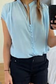 The material definitely feels high quality. I would still put the shirt in a laundry bag when washing just in case. The shirt is semi see through. I'm wearing a black bra in the picture to demonstrate how see through it is. I love how flowy the shirt is! - May L.