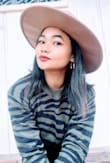 The material at first was itchy cause the material is more of a wool blend. It fits perfect and the color and design is beautiful. I got used to the material and now am loving it, I think after the first wash it goes away so you can enjoy the sweater. - Donia M.