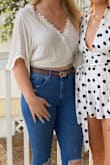 This is one of my go to shirts. It looks so cute with everything and you can dress it up or down depending on how you style it. I always get so many compliments when I wear this. The only thing I found is that I have to safety pin the top together a little to show less but that's more of a preference. - Melissa S.