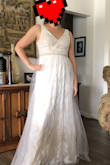 It has an antique look to it; it's cream and not white. I think it's really beautiful. Quite a few of the pearls on the belt were loose- at least 3 missing, so I knocked it down a star. I don't think you would be able to tell unless you're focused on it, so I decided to keep instead of return it. I'm glad that I got a large. - Chris