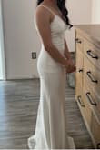 I ordered this dress because I had to have a last minute wedding ceremony during COVID. It got here right on time and it was amazing. It fit me very well, the material was thick which was great because it wasn't see through. It fits very well. Sorry, didn't want to add my face in the picture. - Karime V.