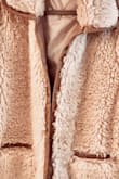 I knew from the first time I saw this jacket that I had to have it. The color is so creamy, it is so fluffy and the faux leather piping around it and the pockets just give it a perfect flare. I absolutely love this jacket! I am going to say it runs small because I ordered a Large because I dislike tight coats and it fit perfect. I would definitely order a size up. Great Jacket, Fabulous Price, Wonderful Customer Service and Fast Shipping, this purchase was a Win, Win, Win, Win! - Deborah K.