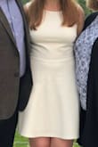 I wore this for my HS graduation. I was worried about the open back making the front sit weird but no problems there. Nice clean white but not see through at all. Only weird thing is the fabric is kind of a neoprene feel which I wasn't expecting but wasn't a problem. - Bethany A.