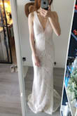 I fell in love with the lace pattern when I saw the pictures and the actual dress look exactly the same as shown in the pic. Would be even better if it has a slightly longer train. I'm a size XS but since it ran out of stock I ordered a S to have a try. It indeed runs loose but can be fixed by a small alteration. - Jane C.