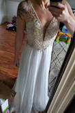I loved this dress! The top is more beige than white but the beading is beautiful! The dress is long on me but I am 5 foot 2 inches. Could easily be hemmed. I bought this dress twice but ultimately sent back both times because as much as I wanted to love it on me it just didn't feel like the one. Its beautiful though! You must try it for yourself! - Jessica A.