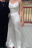 Beautiful dress. Very high quality. I was a little doubtful based on the price, but followed other reviews and I was not disappointed. Great fit without alterations. I am have an athletic body. I usually wear a 2, but by measurements the site directed me small-medium, but I ordered the xs and s, kept the xs. Bosom was a little big, used the stick on bra which I had to partially cut the sides of. You would want nipple petals at least with the satin fabric. If I had a reception instead of an at home zoom wedding, I think I would sweat through the material dancing. - Elisha M.