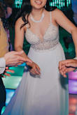 The dress is true to size. There was some weight to the dress which was to be expected because of the beading up top. The bottom of the dress was not see through even though it was white. If you feel like you might be in between sizes, I would suggest going smaller because of the way the dress cuts in the front and in the back. - Sandy L.