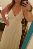 I absolutely love this dress! It feels and looks great! The under layer is slightly form fitting around the waist and hips but not snug. The dress is slightly heavy giving it a bridal feeling making me think I might actually use this as my wedding dress versus just a rehearsal or honeymoon dress, The only alteration I may make is to the straps. Because there is some weight to the dress the spaghetti straps may cut into my shoulders when wearing it for a few hours. - Colleen M.