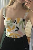 Based on the model, I should've ordered an XS but I thought the S would fit much better and it does! Love the print, it reminds me of Henri Matisse and the colors are so charming and unique. There's a white layer underneath to keep anything from showing. The only issue I had was that the straps are a little loose and are not adjustable, however I'm sure I can fix this with a little sewing. I highly recommend! - Lilly C.