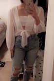The top is see through but I was expecting that when I got it! I paired it with a bandeau and it looks super cute. It fit true to size. The fabric isn't super comfortable (probably bc it's polyester), and it's very thin, but I'll make it work! I got it on sale so I thought it was worth the price. - Alyssa S.