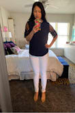 Based on other reviews I decided to go up in size to a medium. I think a small would have been fine too, but was concerned about length. The fit of this shirt loose. If between sizes I would pick based on what's most important (ex: if wanting it to be longer go up in size, if you have a smaller frame/bust choose the smaller size, etc.). I am tempted to buy this in other colors because I like it so much! - Alexia K.