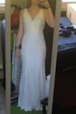 I love this dress! I tend to be between small and medium in Lulus, so I tried on both. The small is fitted and hugs all of my curves. I'm not comfortable showing off all of my curves at my wedding, so I'm going with the medium, which fits a little looser and flows nicely (pictures taken of the medium). The small came with a crooked seam in the middle, but I'm not sticking with the small anyways. The fabric is super soft and stretchy, and very comfortable. The lace is gorgeous, and I love the open back. I'm going to ask my tailor to put in cups, trim the hem if I can't find higher heels, and trim off the lace around the seams (since the bits of lace aren't really my thing). Definitely excited for this dress for my wedding! - Brittany E.