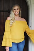 I bought this top to wear for my senior pictures, and it's exactly what I wanted. It fits true to size and the color is the same in person as it is in the photos online. I love the 70s vibe from the bell sleeves, and the subtle sexiness from it being off the shoulder. The ruffles and polka dot texture add to the cuteness. This is the perfect blouse for spring or summer. I'm in love! - Magen H.