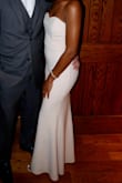 I absolutely love the fit of this dress! The top has a thick clear edge around it to help the top stay in place! The dress is the perfect length!!! As pictured in the model, the dress does not cover the feet all the way, but with the little extra room you're able to walk without tripping over the dress and show off your shoes! Absolutely love! - CyVanie R.