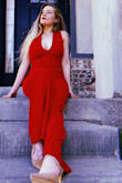 I cannot tell you how obsessed I am with this jumpsuit. It fits perfectly in all areas. Hugs my curves well and the backless aspect is so flattering. I got a size small and couldn't be happier. - Kyriae S.