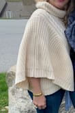 The poncho sweater is heavy and is more a sweater with sides.  Not a true, over the head, poncho.  Give it a try.  Do not put in the dryer. - Robyn S.
