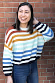 I absolutely LOVE this sweater! It's super comfy and cute. However, even as a cropped sweater it is very small. I'm normally a size S, but ended up exchanging for a L. While it is a little wide on me, the sleeve length is much better on me with this size. - Audrey A.