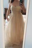 This is a princess dress, super beautiful and fits true to size chart. There is a rubber-type lining at the top that keeps the dress in place, but I also wore a strapless bra and I felt very secure. The only downside is that this dress leaves a trail of glitter in its wake. If you don't feel like dropping pounds of glitter on every possible surface you walk over or touch, then skip this dress. - Cara R.