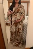 I'm 28 weeks pregnant and looking for dresses to get me through the summer. This one is beautiful and will be worn even outside of pregnancy! The material doesn't stretch and runs a bit large but because you tie it in back, it's fine. I could probably get away with a S but it's not necessary. And even though I'm currently 15 lbs heavier (135 lbs pre pregnancy), I still ordered my normal size. I have a large chest and I actually like that it's not revealing. Smaller chests might find it baggy in that area. It's super elegant, silky, and flowy and just cut really well. I'm short so there's a good 4-5 inches I will need to hem. - Katrina X.