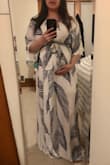 This dress fit me perfectly. I'm 28 weeks pregnant and normally 135 lbs pre-pregnancy but I know I'll still be able to wear it after having my baby. I ordered my normal size which is M. The print and colors just makes me feel summery and it's soft and flowy. The single snap button on the chest allows for you to have a more revealing chest area if you want. I'm short so there's a few inches I'd hem off the bottom. Overall very flattering on me and helps hide my fluffier shape! - Katrina X.