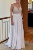 My large wedding got postponed due to COVID, but we're still having an intimate ceremony -- so I wanted to wear a different, more simple dress. This dress is more perfect than I could have imagined, and all for a fair price and easy shipping! It's seriously gorgeous in person. A simple dress, especially the silhouette, but so glamorous at the same time -- there is no doubt I'll feel like a bride on our wedding day! I will be wearing 4 inch wedges but still had to get a few inches hemmed off the front (left the back long like a little train). The top area almost fits me like a glove, but depending on the position of my shoulders, the V-back will gap open. I'm hoping some body tape will help solve this problem on the wedding day, but even if it doesn't... I still love this dress. I'll try to update with a new photo after the wedding day! - Jayne K.