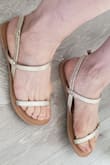 I wear a size 5 with open-backed sandals and I got the size 5.5 and it fit perfectly. There is a small overhang on my heel which I find very sexy. I mean that the sandals are slightly shorter than my foot length.  The straps are very comfortable and snug on my feet. - Rene A.