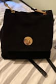 This bag was even nicer in person. It's a beautiful soft suede in front with gold hardware. It's my new go to bag! - Maggie A.