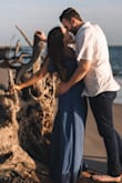 Due to COVID-19 I did not have any stores in my town open to find a dress for engagement photos. I surprisingly loved this dress so much! I purchased it in 2 sizes due to running short on time for pics and went with the XS instead of S. Being so short, I had to get 4-5 inches hemmed off of the dress bottom so it could just skid slightly over the floor. Even wearing a 4 inch wedge did not allow for me to skip getting it hemmed like I thought it would since I enjoy wearing high shoes anyways. Half of my photos are with wedges and half of them aren't just because it looked more natural without shoes! Overall I am happy with my purchase and I think if you are over 5'4" you should be fine getting this size and it not being too long. - Tiffany A.