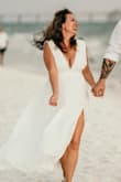 It's a beautiful dress, well-made and fits good. I just have to hem it up because I'm short. I also had the slit change to flow a bit better. I wore it for my beach wedding - Nikki G.
