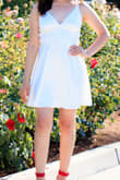 I got so many compliments on this dress. I used it to take my graduation pictures. With all the straps that this dress has it is actually very easy to slip on and off. It is not too tight and you actually breathe in it. The dress does have a shiny look to it but it feels great. Overall a great buy. - Idalia C.