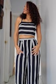 The material is very light and comfortable. The pants are high enough to feel comfortable showing a bit of midrift. The pants are long but the length allows it to wear with heels with no problem. - Susan F.