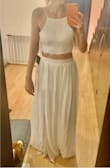 The dress finally arrived today and it is really nice BUT a few things worth mentioning are: the skirt is NOT as long as the reviews or the description say it is, I'm 5'6" and I don't think I'll be able to use heels (which doesn't really bother me but still...), another thing is that the waist is tight on me so I'm guessing I'll try to loose some weight and hope it fits better. The top is really nice and I actually like it better in person than in the pics, it is a little loose for me but I have no boobs so... lol. Overall I wish I had ordered a Medium (I'm from MX so I can't change sizes) but I really like it, the quality of the materials is good and I'm planning on wearing it for my civil ceremony once the COVID allows us to do it. - Daniela A.
