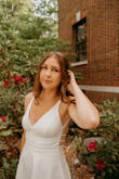 I wore this dress for graduation photos and loved it! The material is great and the white color works well to match to other things. I do wish the one strap that is the furthest out on the shoulder (on the back side) was a little more towards the center. I just didn't love the placement of the strap, but other than that great dress! - Jordyn B.