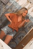 This is my new favorite top! I've already worn it multiple times since I got it. Fits perfectly and looks just like the picture online. Ordered a size small in the burnt orange color. I tied it up in a knot to go over my shorts in the photo but looks great worn normally with jeans too! I've gotten compliments on it every time I've worn it! - Lauren B.