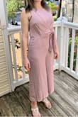 The fabric is what I'd expect to wear to a wedding or something, which means not as soft as I'd hoped, but it's not bad. I'm worried it will start fraying at the seams after regular wear. However, it fits perfectly (you won't be able to wear a regular bra because the strap will be visible, but I found out I could get away without one) and it complements my figure very well. The pants aren't too baggy or too long/short and the front tie is customizable so it's not too tight. The color is difficult to pull off and I recommend it for pale people like me, but I was planning on tanning this summer which may make the color not look the greatest. But this is my very first jumpsuit and I am happy with it! Looking forward to wearing it out! Love the pockets!! - Jacqueline W.