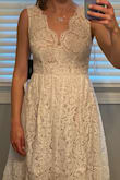 I am usually a small or medium with Lulus, but based on other reviews that the dress runs a little small, I went with that. It fits super well, length was right on me. I was looking for something knee-length for our (now) backyard wedding. I loved a lot of it, but the under layer is tan (not white), giving it a darker look than the photos in my opinion. It didn't work for what I was going for. But it is a very flattering dress. - Katherine Z.