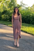 Wore this dress to an outdoor wedding and it was perfect for the occasion! I ordered an XS (a size smaller than my usual) after reading other reviews, and found that it was a little tight in the bust area. I would say to order a size smaller if you plan to wear it without a bra, and order your usual size if you plan to wear it with a bra. The slit on the dress also runs all the way up, so it can be revealing if you're not careful. Overall it was a very flattering dress though. - Rebecca J.