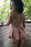 This romper is perfect if you love summer dresses and don't want to worry about wind blowing your dress up! I ordered it in black first and liked it so much I got the pink too. Very flattering waist line. I like the bow in the front or back. And the straps are adjustable for however much cleavage you're comfortable with. Also thick enough to not need a bra! - Jacqueline G.