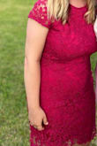 This is a great dress! It was about knee length. I ordered a L and it looked a little tight but it didn't feel tight. It does show any type of curves or extra weight - I was a little self conscious because my stomach is not totally flat. I wore spanx and it helped. Some parts of the lace at the bottom do stretch out - I could see the strings becoming loose or worn multiple times. I loved the "v" back, high neck in front and bright pink color. - Allison E.