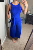 I am OBSESSED with this jumpsuit! It is super cute & fits like a glove. I'm glad I read the reviews because I'm normally a small, but sized down to an XS and it fits perfectly. IT EVEN HAS POCKETS! It's not too tight anywhere and is made of a comfortable material! Love love love this! - Kylee S.