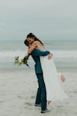 I bought this dress for my elopement after my wedding was postponed. I wanted something affordable to replace my original wedding dress because I wanted to save that for the big wedding. I recommend this dress 100%. I had to get it hemmed because I'm only 5'2 and it got the straps taking in a little bit, but it fit around my waist perfectly. The material is great and overall, the dress is pretty comfortable. The hanger straps are right where the mesh is so you do have to cut those. I wish I had cut those shorter! Overall, it is such a beautiful dress and I would recommend it to anyone. It was perfect for our beach wedding, but it would look good in any wedding setting! - Madelin W.