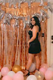 I bought this dress for my birthday and I got so many compliments on it! The satin is so soft and comfortable. The back zipper goes all the way down which makes it easy to get in and out of. It also has adjustable straps which helped it fit even better. It's tight/fitted on top and has a looser fit towards the bottom. I would definitely recommend this dress! - Sarah G.
