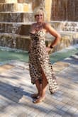 This dress fits true to size and was of good quality! If you want to get your sexy on this is your dress, if not you may want to pass! Slit reveals quite a bit of leg and cowl neck reveals top of bust-Love the dress and would highly recommend the purchase if you want to unleash your inner leopard! - Sue B.